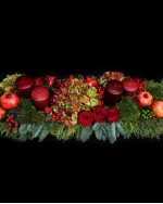 Arrangement of hydrangeas, pomegranates, roses, ilex, fir and candles 