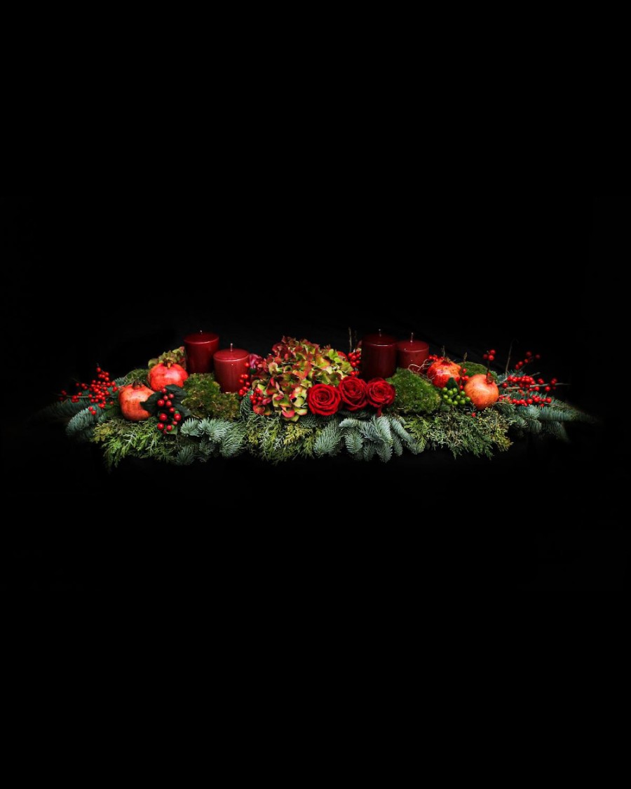 Arrangement of hydrangeas, pomegranates, roses, ilex, chestnuts, candles and fir 
