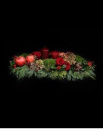 Arrangement of hydrangeas, pomegranates, roses, ilex, chestnuts, candles and fir 