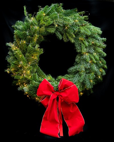 Handmade Christmas wreath with red ribbon.