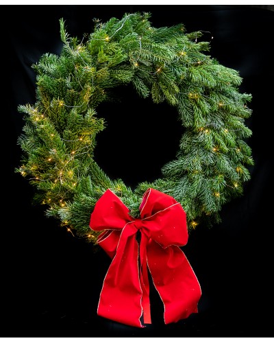 Handmade Christmas wreath with red ribbon.