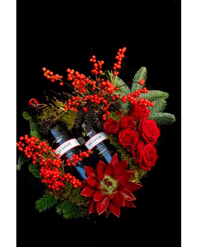 Arrangement of roses, ilex, fir, pepper, echeveria and  two Avaton bottles