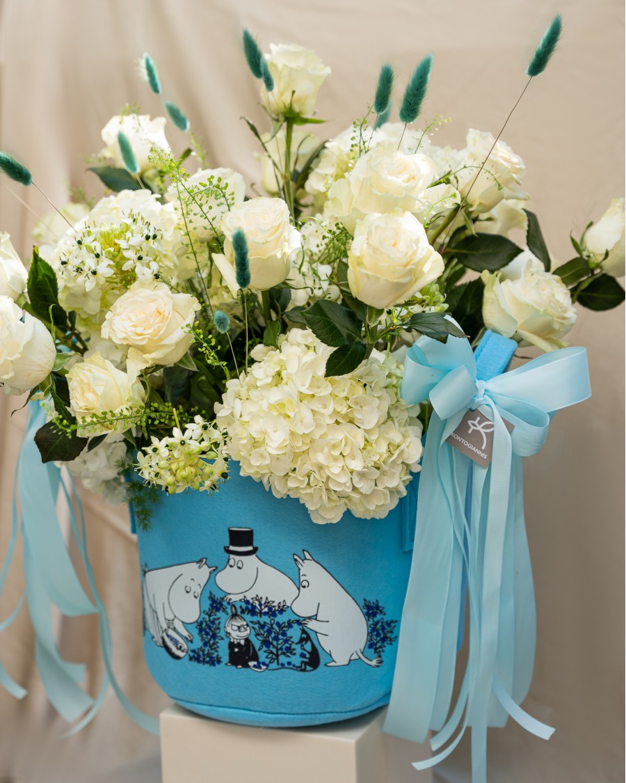 Arrangement of Roses, Hydrangeas and Ornithogalum in Blue Reusable Bag