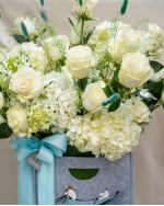 Arrangement of Roses, Hydrangeas and Ornithogalum in Grey-Blue Reusable Bag